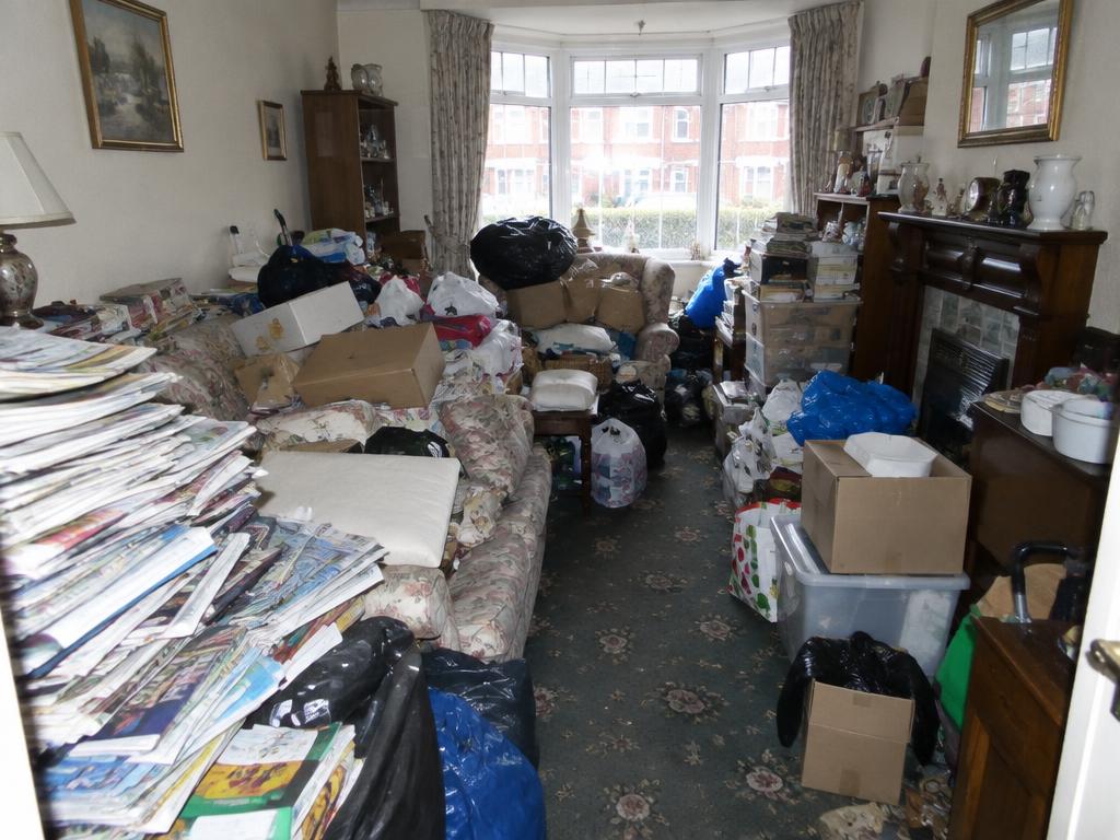 Illustrative living room hoarder clean-up — before cleaning