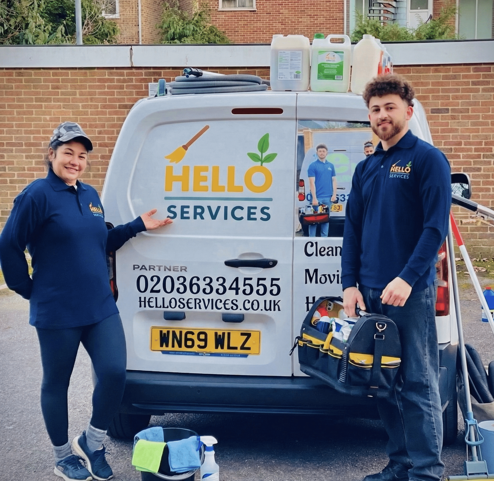 Hello Services cleaning team standing with their branded van, extraction machine and colour-coded cleaning kit