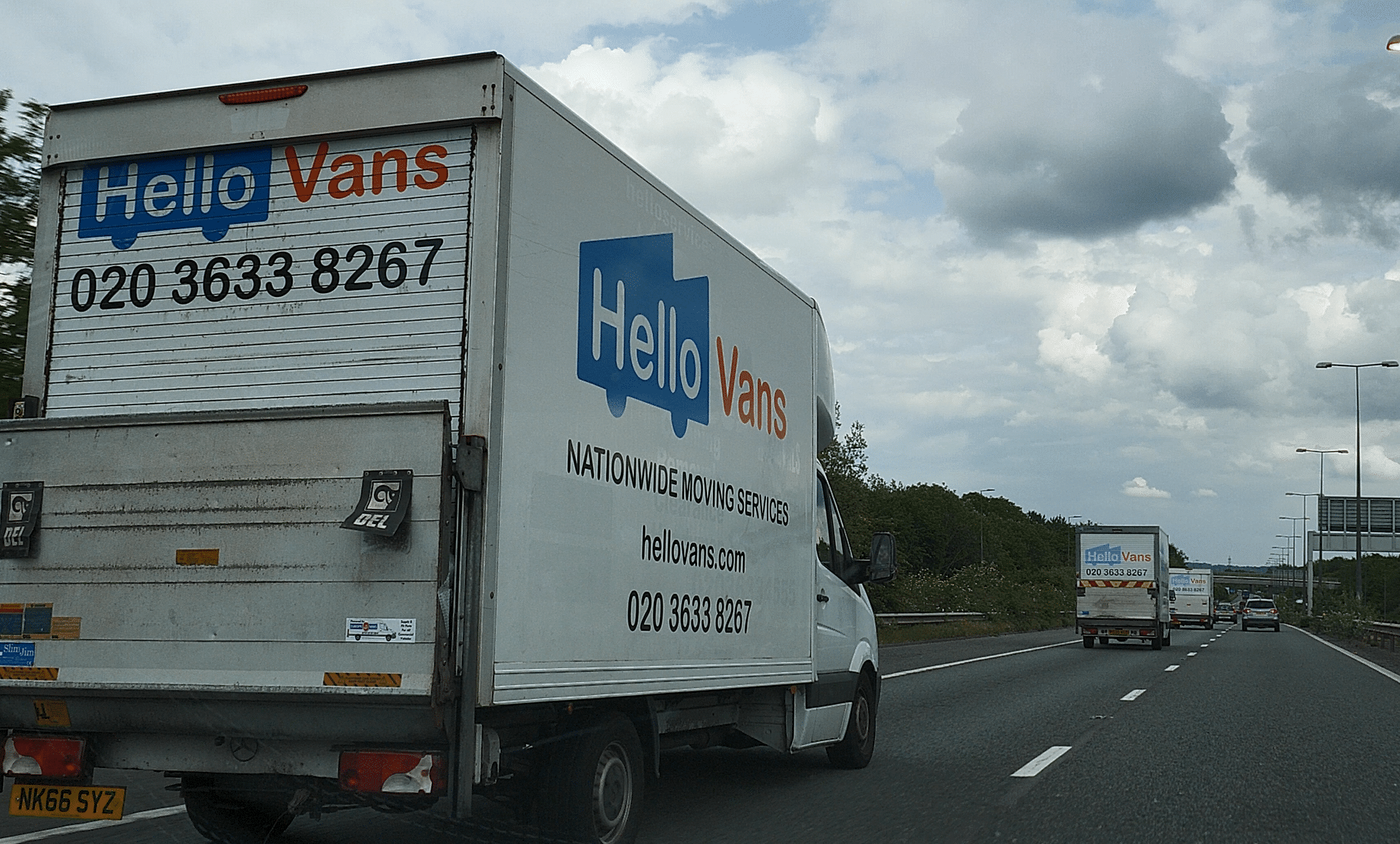 Branded Hello Services removals lorry travelling on a UK motorway during a long distance house move