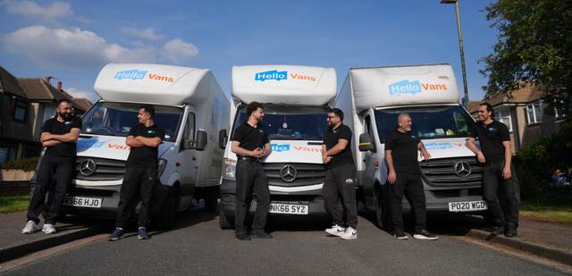 Uniformed Hello Services moving team standing together beside their branded removals van — Office moves in Greater Manchester